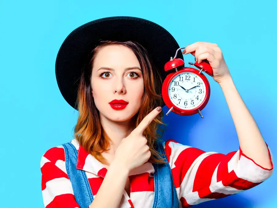Photo of a woman pointing to an alarm clock