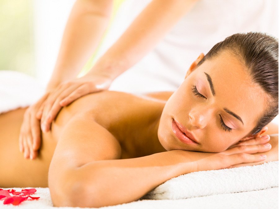 Picture of a woman enjoying a massage while listening to music