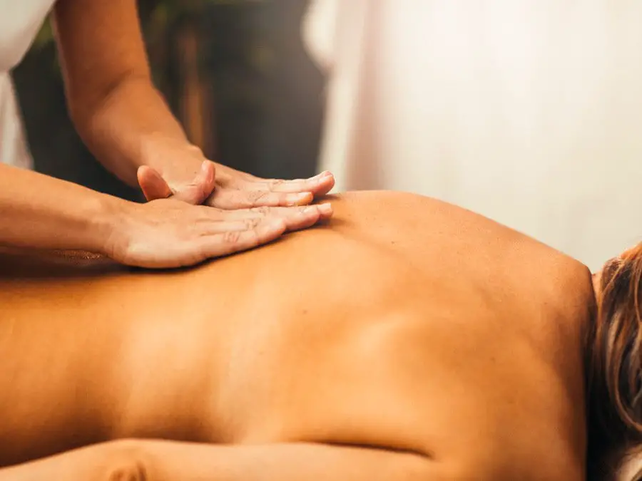 Picture of a woman enjoying a massage with jojoba oil