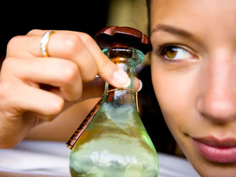Picture of a woman looking at a jojoba massage oil bottle