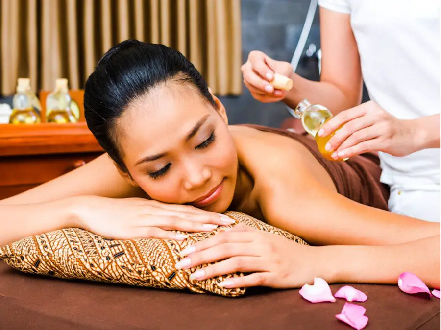 Picture of a woman enjoying a massage with olive oil